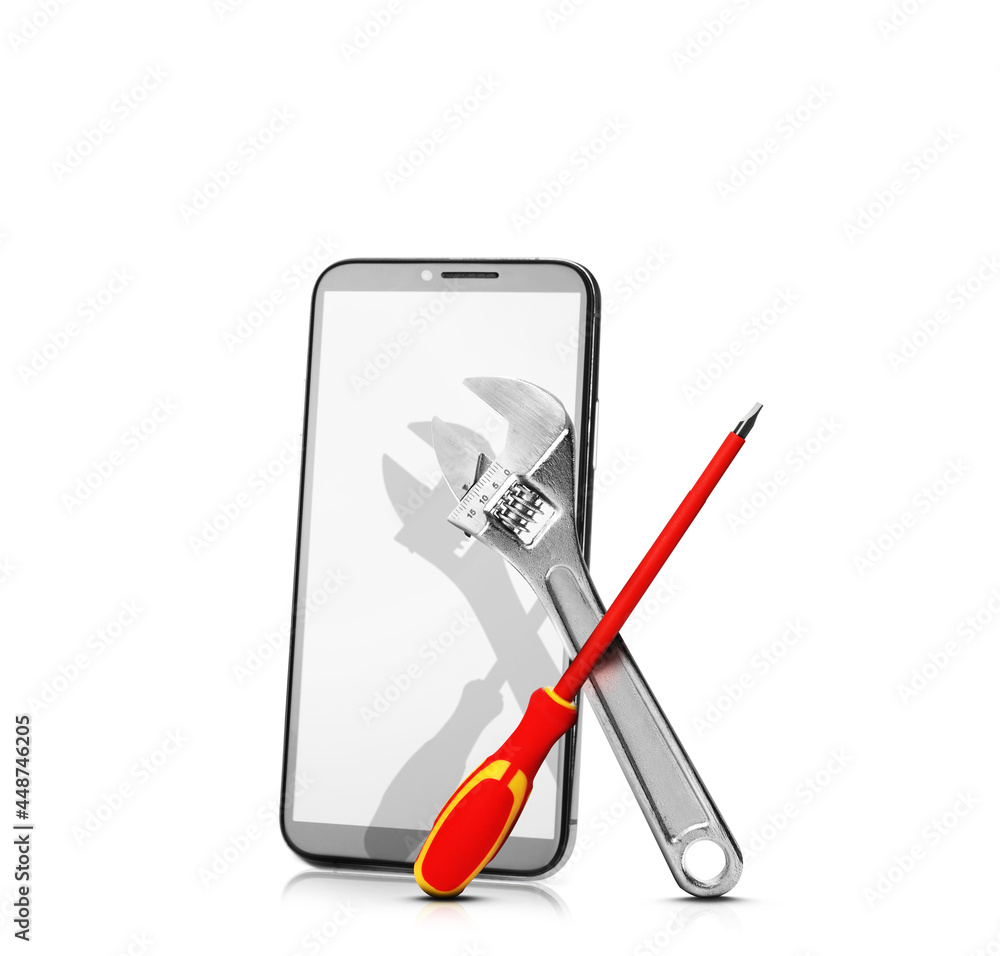 Repairing service. Modern smartphone, wrench and screwdriver on white background Repairing service. Modern smartphone, wrench and screwdriver on white background