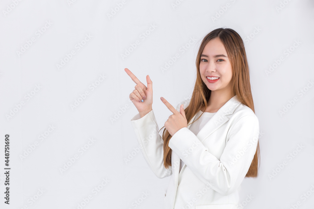 Asian woman with bronze long hair wearing a white suit and pretty smiling is present product on white background. Asian woman with bronze long hair wearing a white suit and pretty smiling is present product on white background.