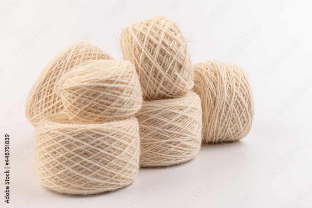 balls of light woolen thread on white background. natural wool. knitting. background balls of light woolen thread on white background. natural wool. knitting. background