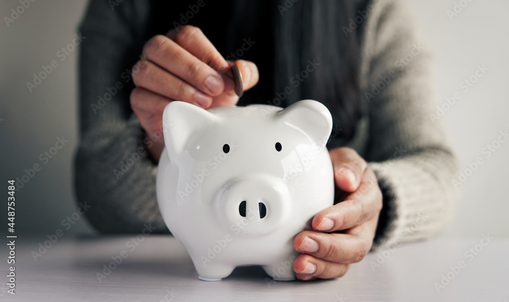 Woman hand and white piggy bank to saving money concept .budget, financial. Woman hand and white piggy bank to saving money concept .budget, financial.