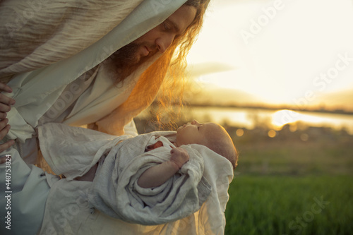Φωτογραφία Saint Joseph holds baby Jesus in his arms.
