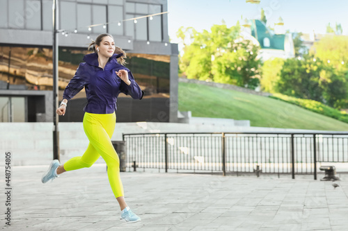 Sporty young woman running ...