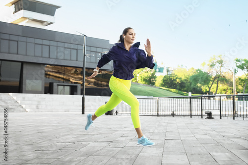 Sporty young woman running ...