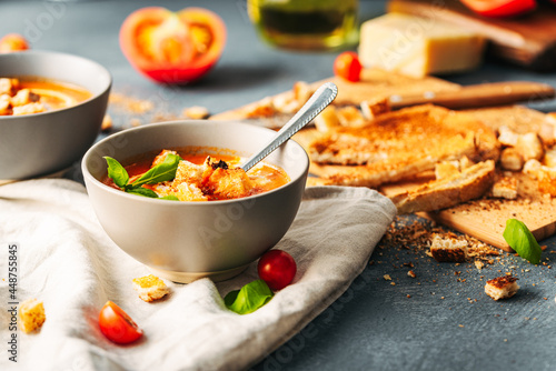 Tomato soup. Tomato creme with basil and bread. Bowl with italian tomato soup. 