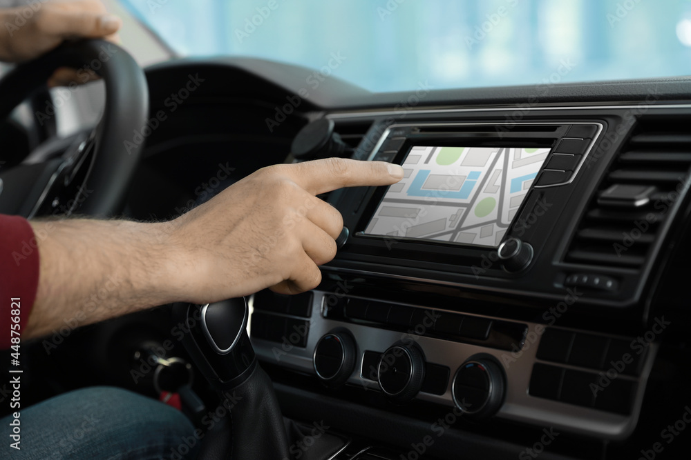 Man using navigation system while driving car, closeup Man using navigation system while driving car, closeup