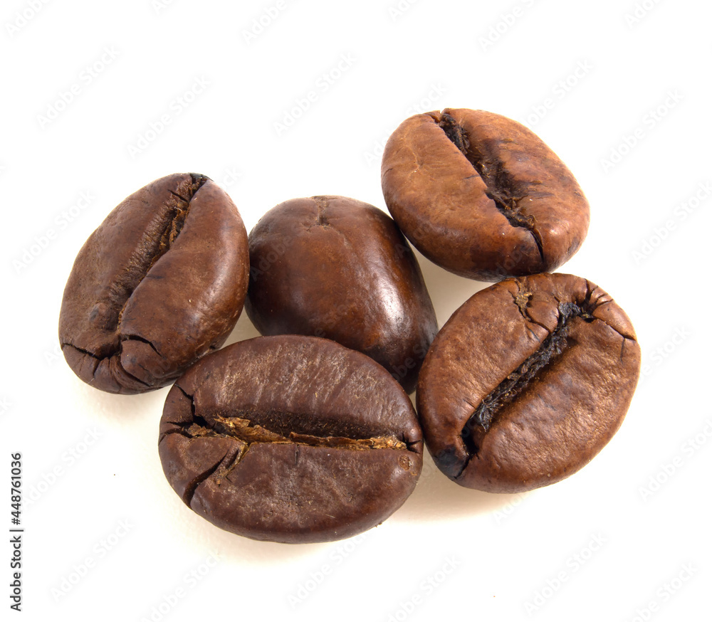 Arabica coffee beans close up isolated on white background. Arabica coffee beans close up isolated on white background.