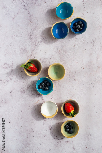 A display of ceramic bowls with berries