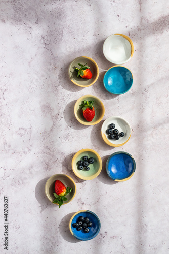 A display of ceramic bowls with berries