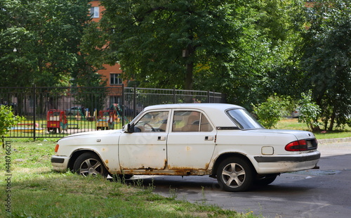 An old white Soviet car is parked in the courtyard  ulitsa Sedova  St. Petersburg  Russia  July 2021
