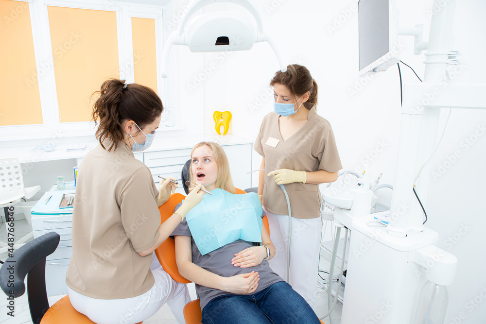 pregnant woman at the dentist's office, checkup and dental treatment for pregnant women. pregnant woman at the dentist's office, checkup and dental treatment for pregnant women.