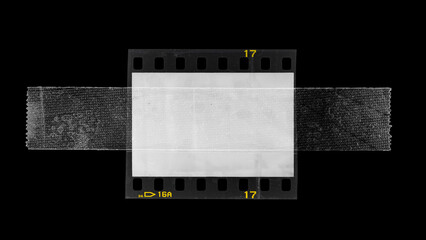 empty or blank 35mm dia film frame fixed by transparent sticker adhesive tape on black background. poster or design element.