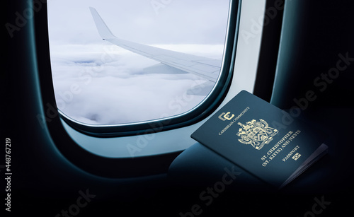 Saint Kitts and Nevis passport on the plane in front of the window photo