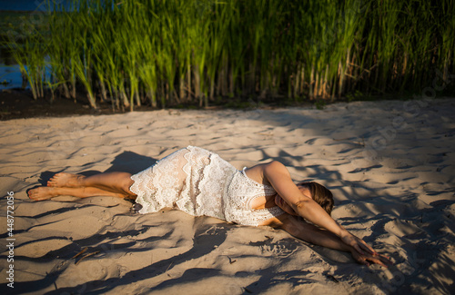 Happy Adult Woman Lay Donw On The Sand Beach Enjoying Summer Sun And Holiday photo