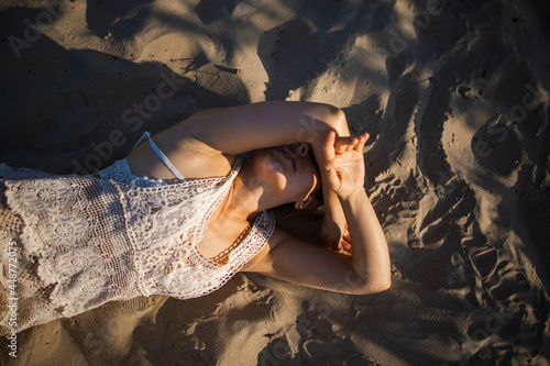 Happy Adult Woman Lay Donw On The Sand Beach Enjoying Summer Sun And Holiday photo