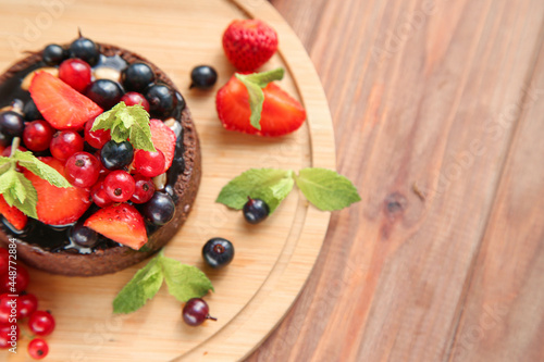 Chocolate tart with berries and mint with place for text. Top view
