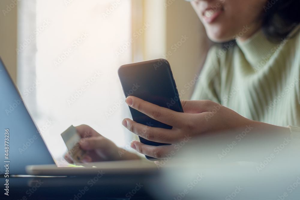 Woman online shopping and payment by using mobile smart phone with credit card Woman online shopping and payment by using mobile smart phone with credit card