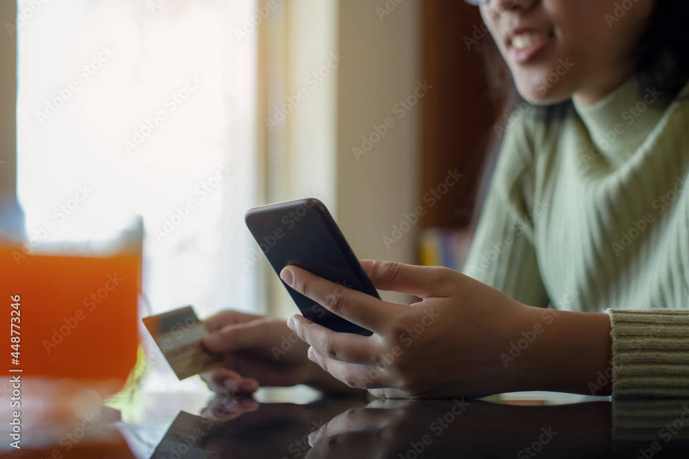 Woman make online shopping and payment by using mobile smart phone with credit card Woman make online shopping and payment by using mobile smart phone with credit card