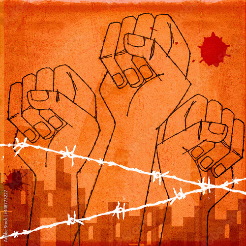 Raised fists behind barbed wire