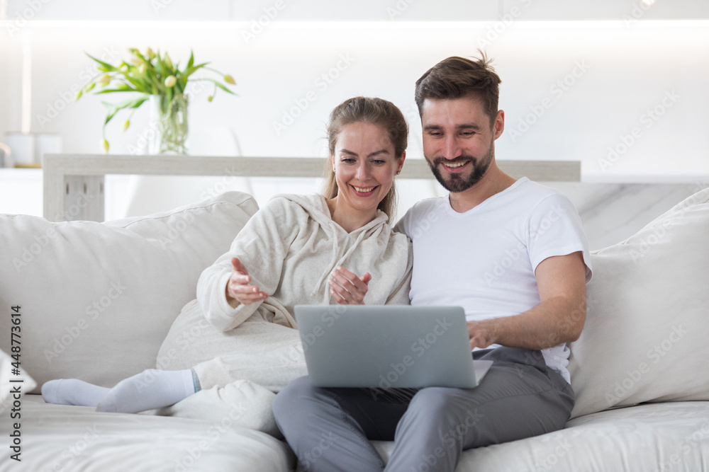 Couple browsing internet in living room