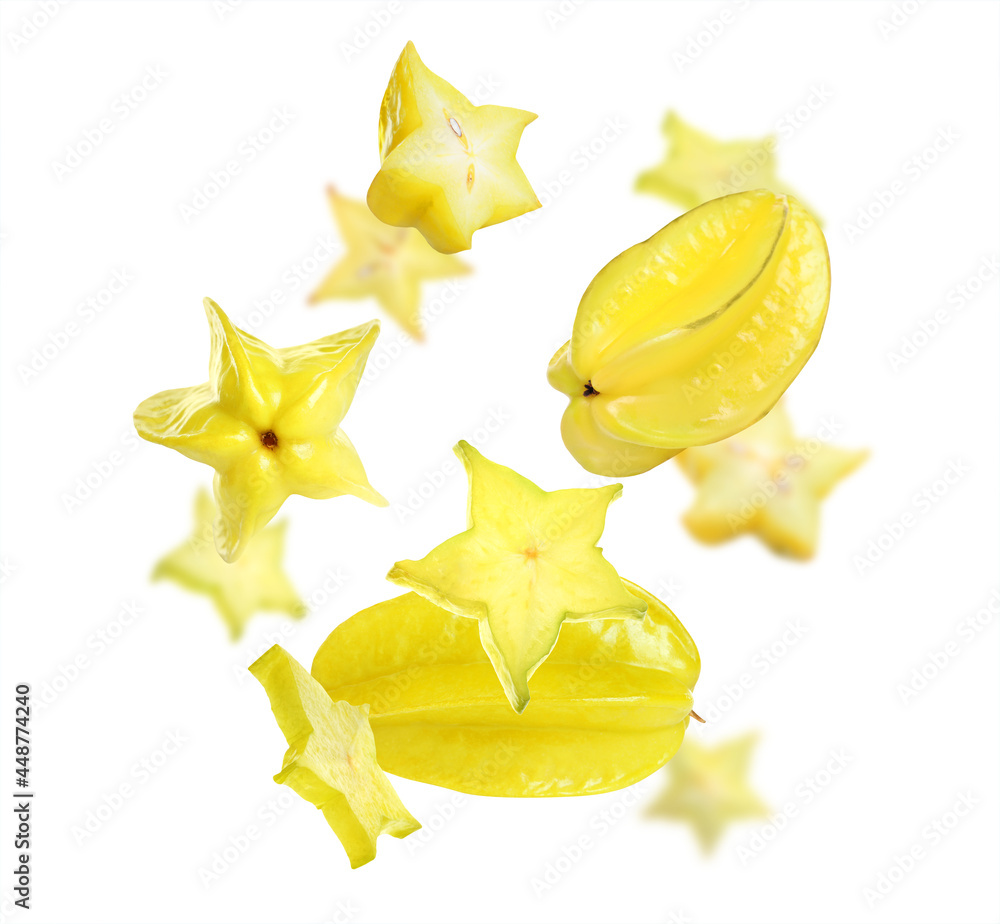 Fototapeta premium Tasty juicy carambolas flying on white background