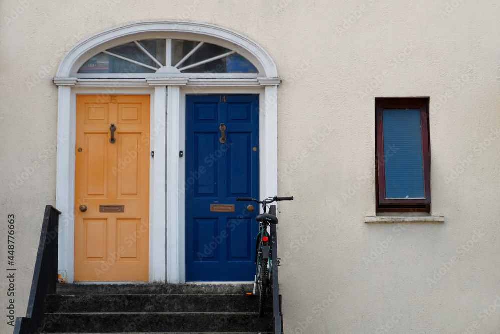 Two front doors and a bicycle (a simple facade)