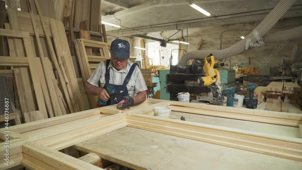 Woodworker Takes Bolts And Screws Them With Power Screwdriver At