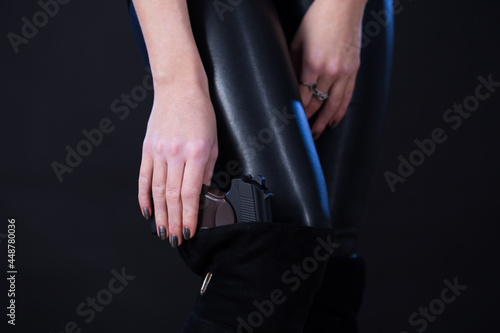Woman pulls out a pistol from a boot