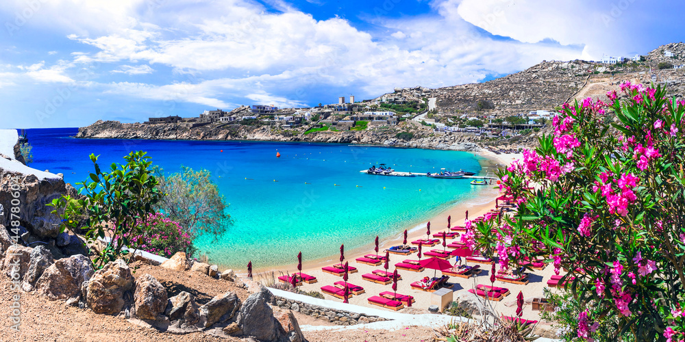 Greece summer holidays. Cyclades .Most famous and beautiful beaches of Mykonos island - Super Paradise beach popular tourist resort - obrazy, fototapety, plakaty 