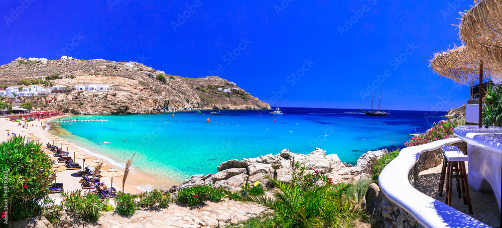 Fototapeta premium Luxury hotel resort view over Caribbean turquoise sea and beach with umbrellas from terrace. Summer vacation destination exotic paradise landscape cinematic 8k travel photography