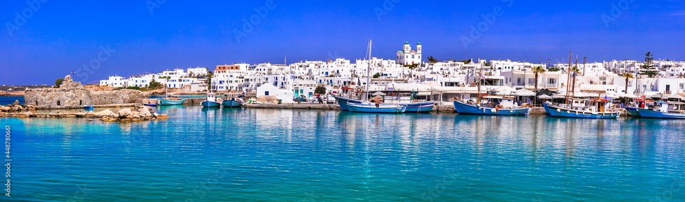 Greece travel. Cyclades, Paros island. Charming fishing village Naousa. view of old port with  boats and street taverns by the sea.