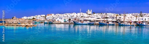 Greece travel. Cyclades, Paros island. Charming fishing village Naousa. view of old port with boats and street taverns by the sea.