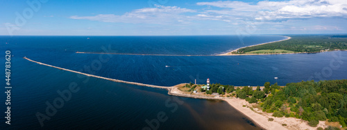 Aerial view of the lighthouse at the river bank and the sea. A place where river floats into the sea. Panoramic view. © Aerial Film Studio