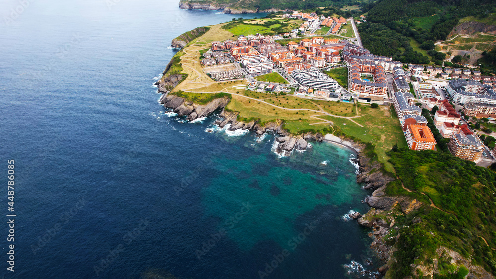 In this imagen you can see Castro Urdiales, its port, its cliff, and its buildings- All of this is ubicated in Cantabric see, in Cantabria, Spain. 