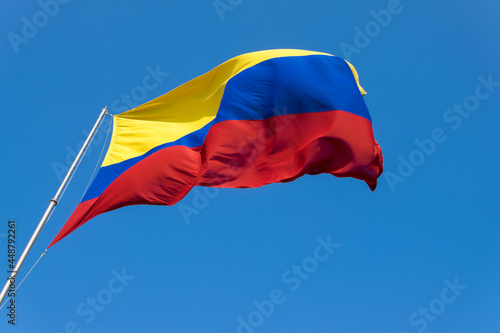 A Colombian flag is streaming in the wind. photo