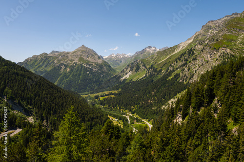 Beautiful view from the top of the Maloja pass in the Bregaglia valley between Switzerland and Italy. It is a beautiful sunny summer day, with blue sky and just a few clouds.