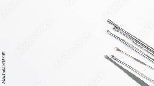 close up steel ear cleaner tools with white background 