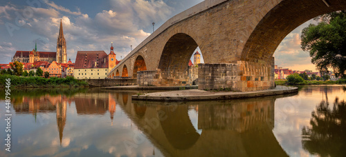 Obraz na płótnie Regensburg, Germany. Cityscape panoramic image of Regensburg, Germany with Old Stone Bridge over Danube River and St. Peter Cathedral at summer sunset. w salonie