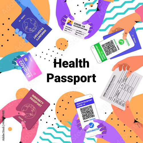 hands holding international certificates of vaccination digital immunity passportson risk free covid-19 pandemic