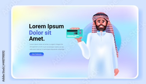 arab man holding debit or credit card electronic wireless payment digital transaction online shopping money transfer