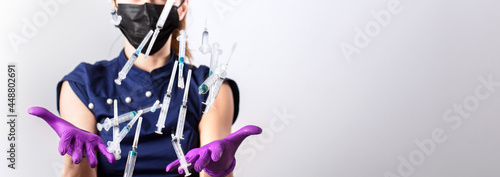 Woman throws up medical injections syringes in her outstretched hands towards the camera. Selective focus, copy space. Nurse: what to do with used syringes?