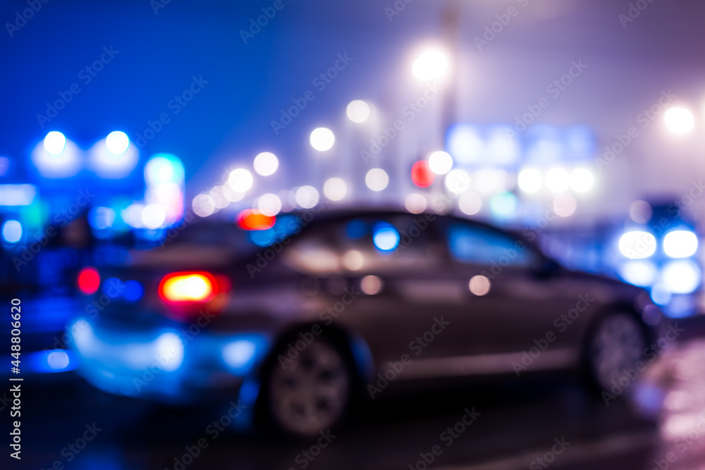 Fototapeta premium City night lights, car standing at the traffic lights. Defocused image