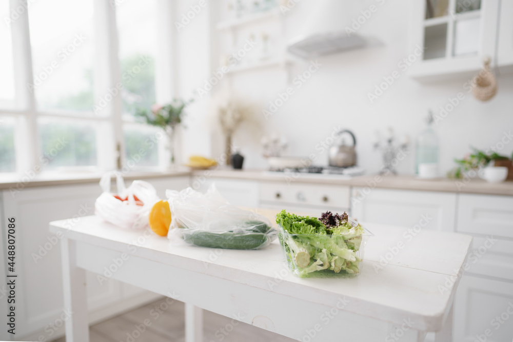 Fresh vegetables and lettuce on white wooden kitchen table