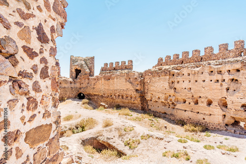 Ancient stone walls of a restored medieval castle photo