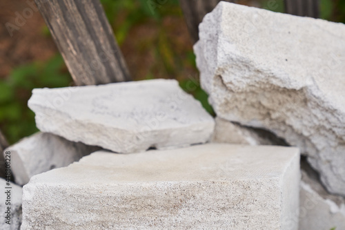 Stone podium. Natural stone pedestal of gray color, on a stone background.. High quality photo
