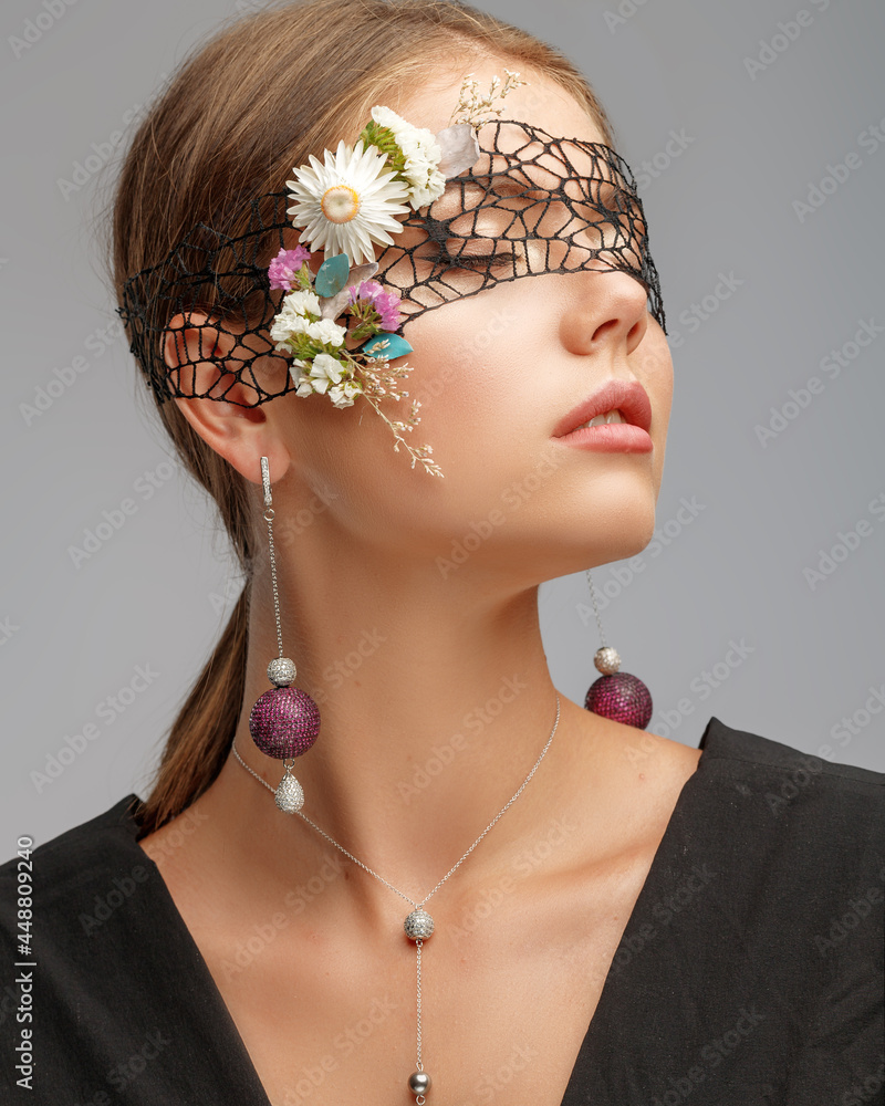 Portrait of an attractive young girl with stylish fashionable jewelry. The concept of female beauty.