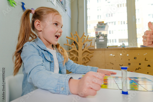 Teacher spreads out puzzle in front of the child photo