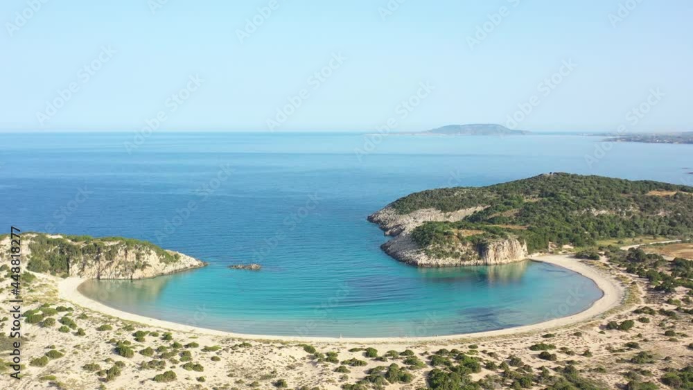 Aerial drone video of semicircular sandy beach and lagoon of Voidokilia, one of the most iconic beaches in Mediterranean sea, with crystal clear turquoise sea, Messinia, Greece Aerial drone video of semicircular sandy beach and lagoon of Voidokilia, one of the most iconic beaches in Mediterranean sea, with crystal clear turquoise sea, Messinia, Greece