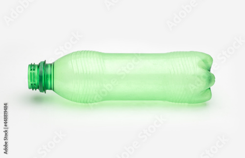 Used transparent green plastic bottle on an isolated white background