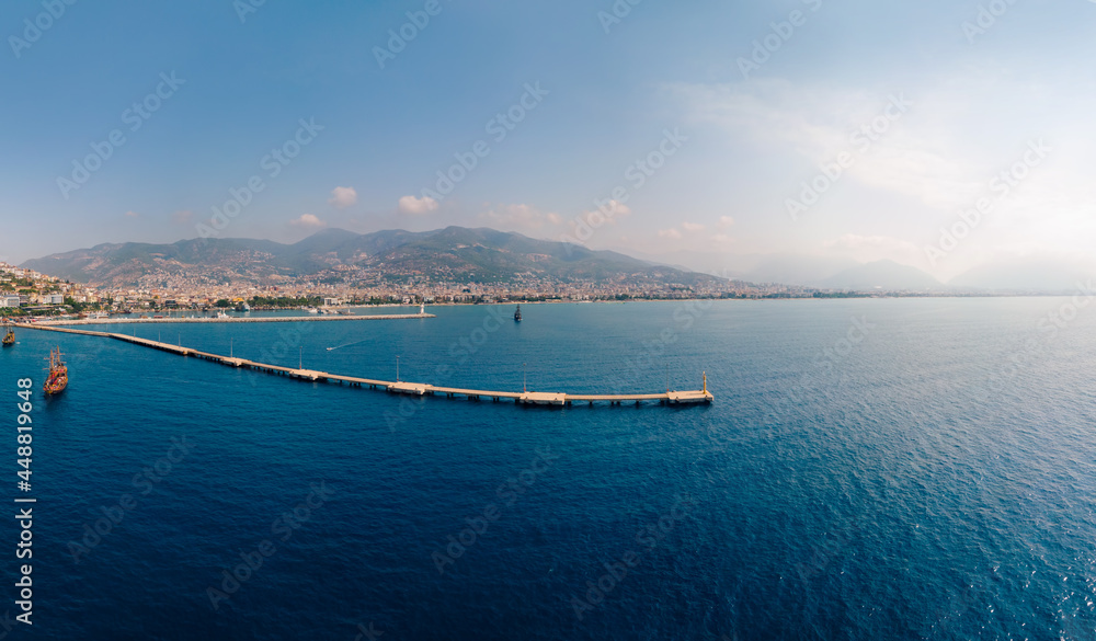 Aerial wide view of Alanya Turkey, Summer morning. Travel and vacation. Ships and boats. Kızılkule bay. lighthouse and pier. Copy space Show program and entertainment for tourists, swimming
