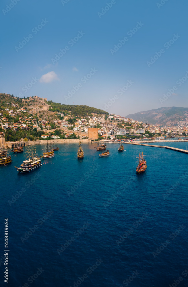 Large panorama. Wide view. Aerial view resort city Alanya in southern coast of Turkey, Summer day. Travel and vacation. Kalesi Castle. Mountain. Ships and boats in the mediterranean. Vertical photo Large panorama. Wide view. Aerial view resort city Alanya in southern coast of Turkey, Summer day. Travel and vacation. Kalesi Castle. Mountain. Ships and boats in the mediterranean. Vertical photo